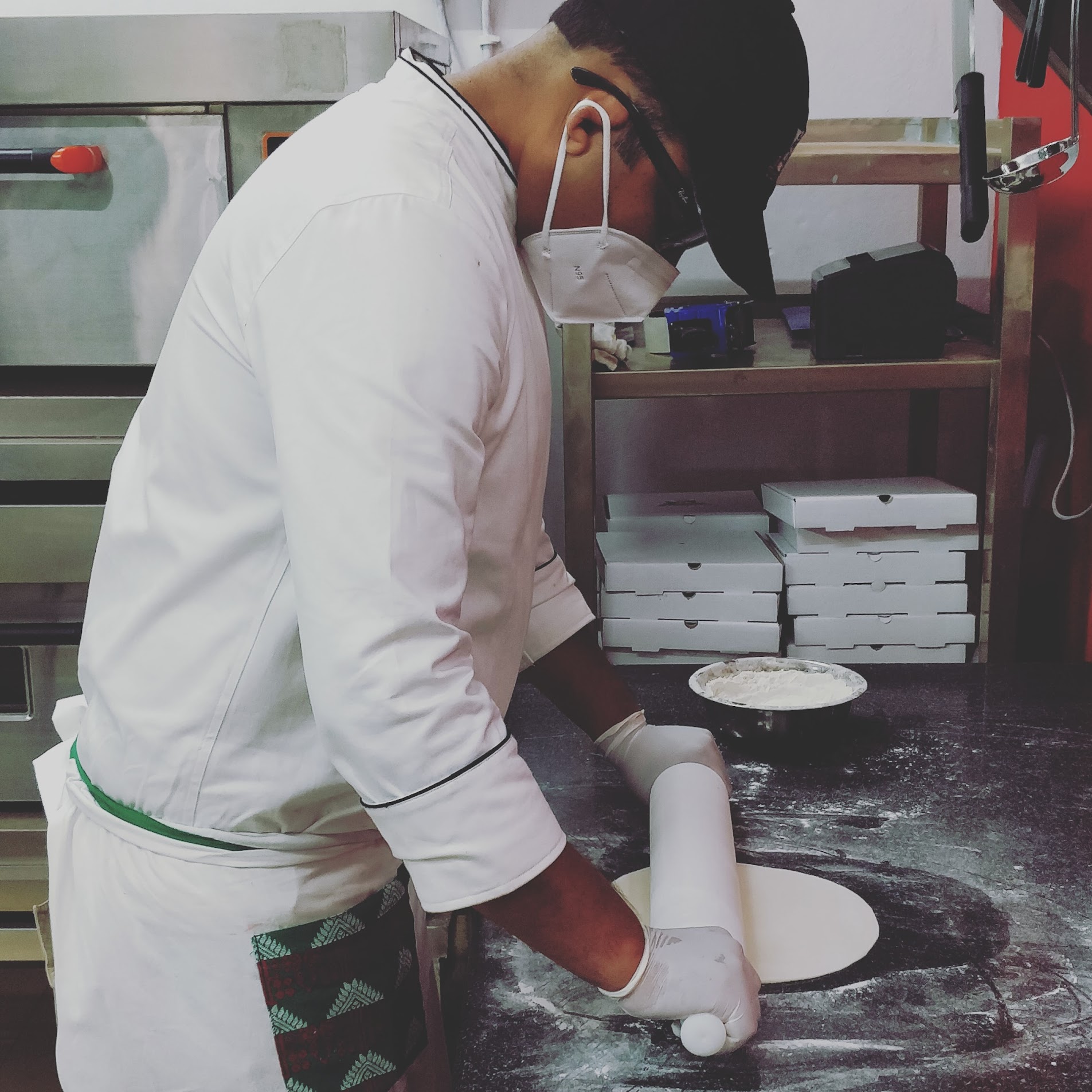 Chef Roy rolling fresh pizza dough daily